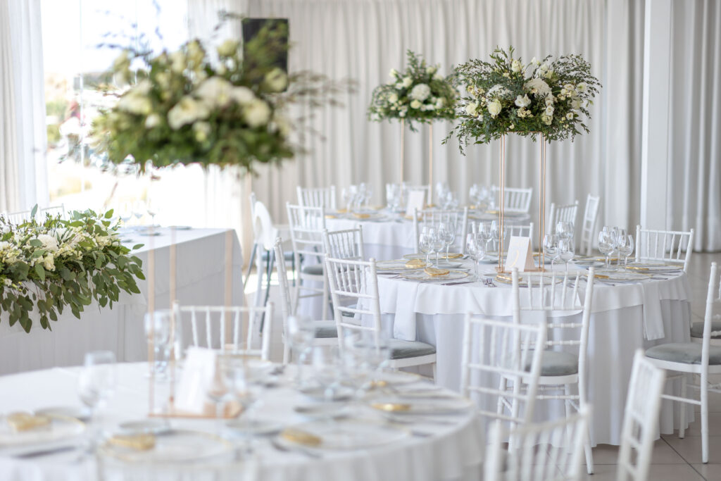 white, green and gold reception styling on tables at Le Ciel Santorini wedding