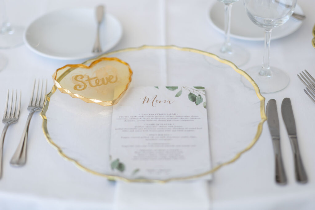 closeup of gold heart place name at Le Ciel Santorini wedding