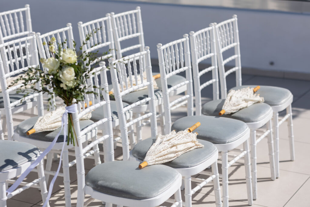 parasols left on chairs for guests at Le Ciel Santorini wedding