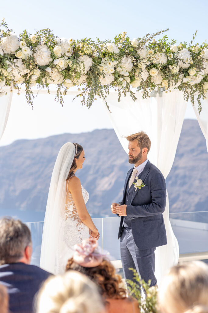 Bethany and Adam saying their vows at Le Ciel Santorini