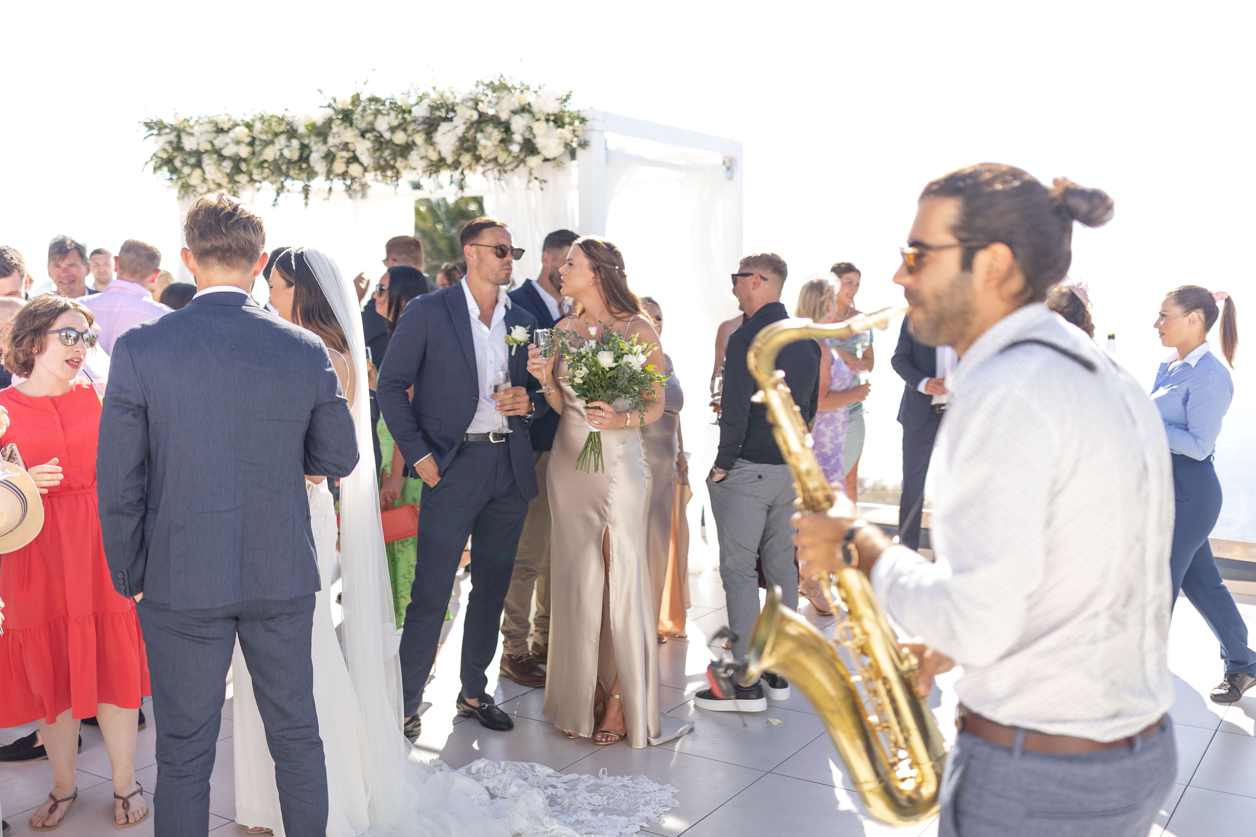 saxophonist playing outside at Le Ciel Santorini wedding