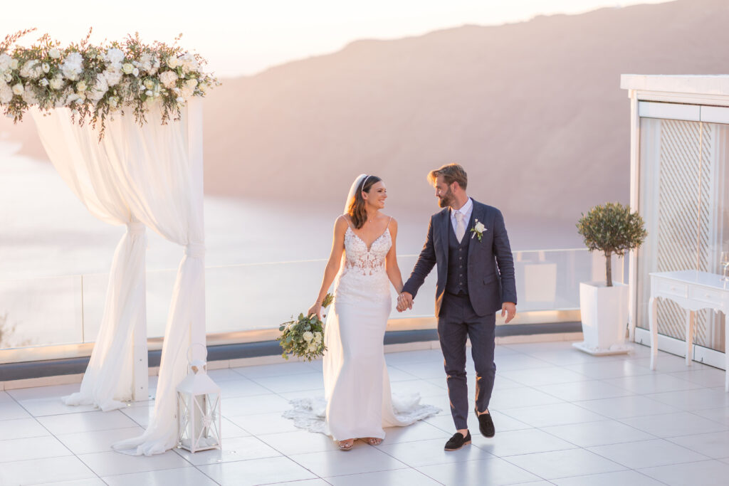 bride and groom walking outside Le Ciel Santorini