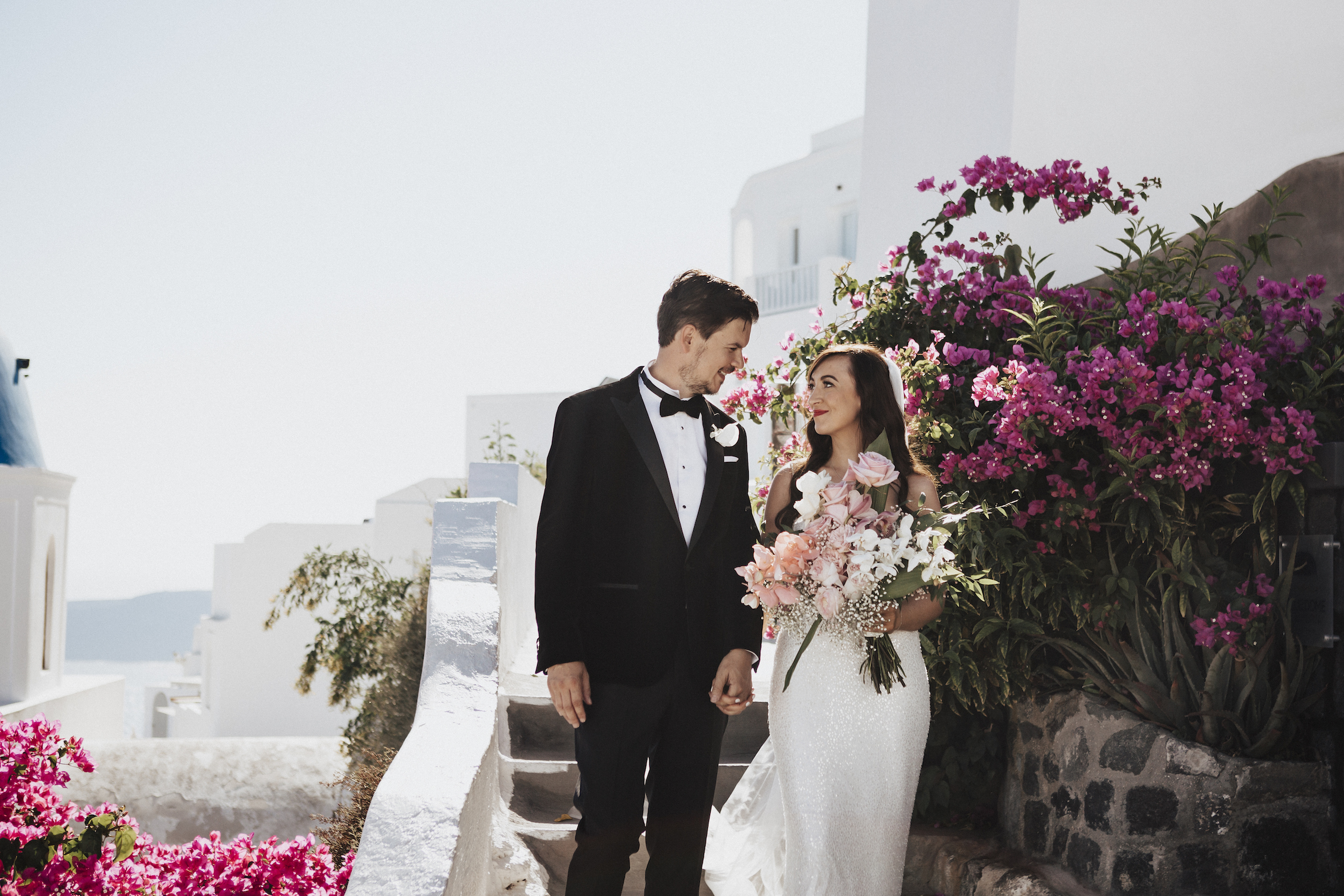 Anneliese and James walking through the streets of Santorini holding hands