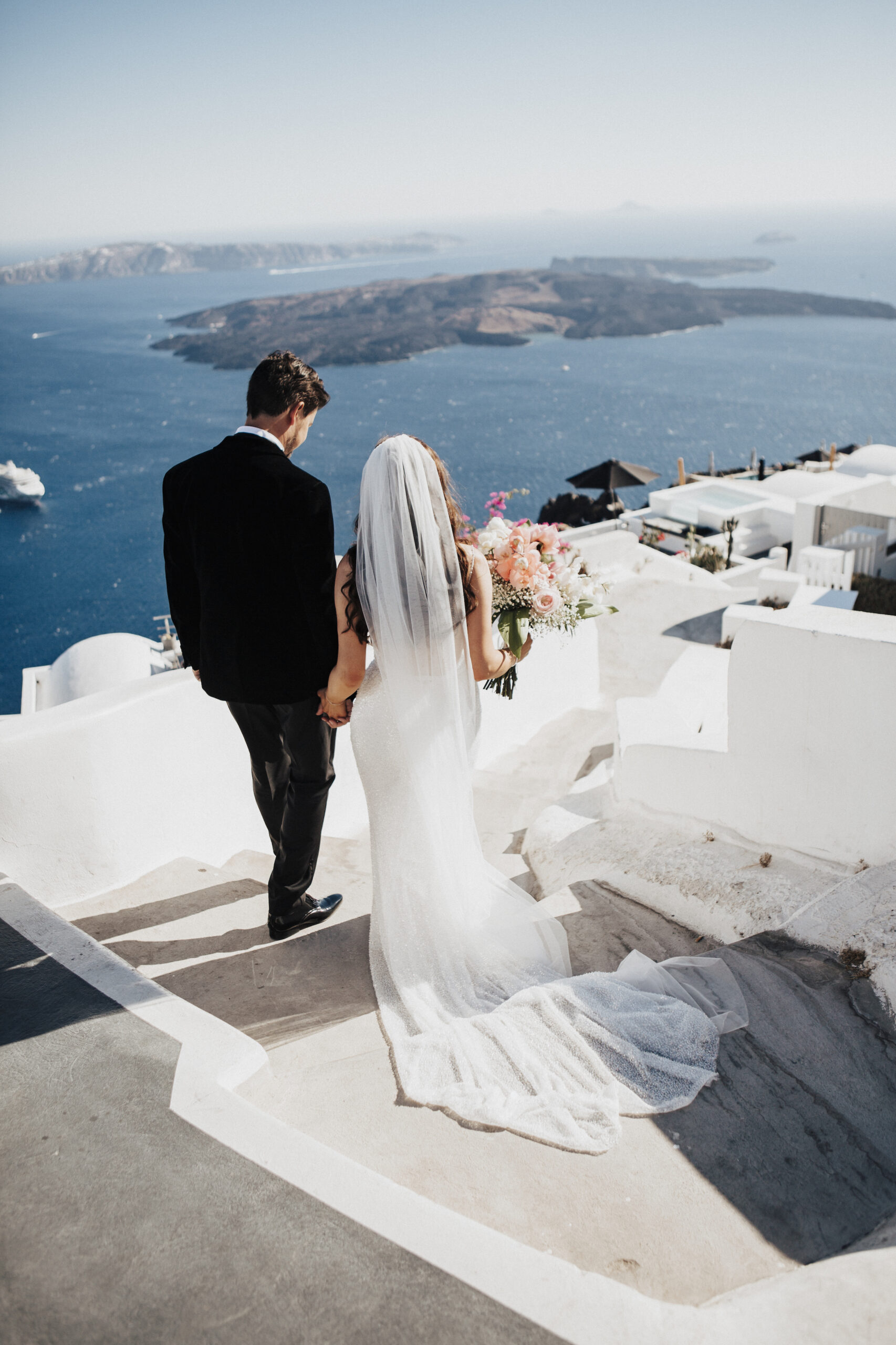bride and groom looking out across the ocean at Le Ciel