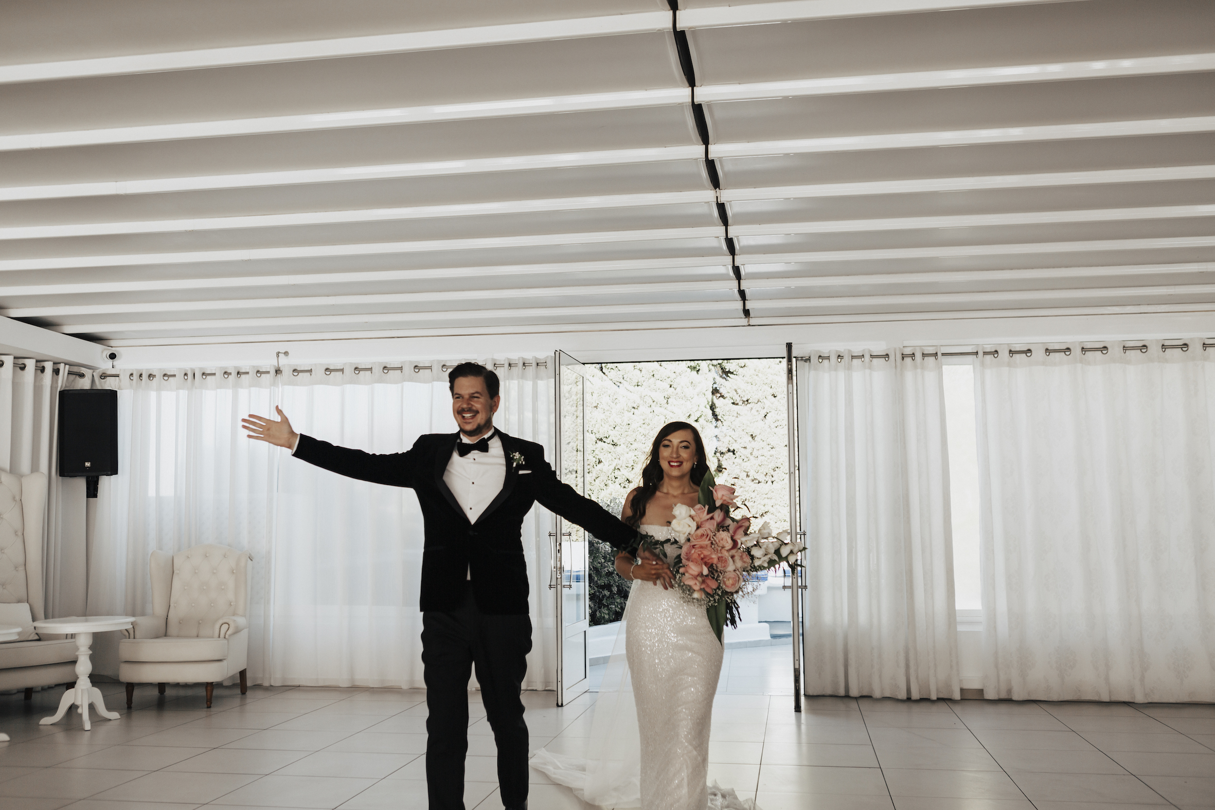 bride and groom walking onto Le Ciel reception room