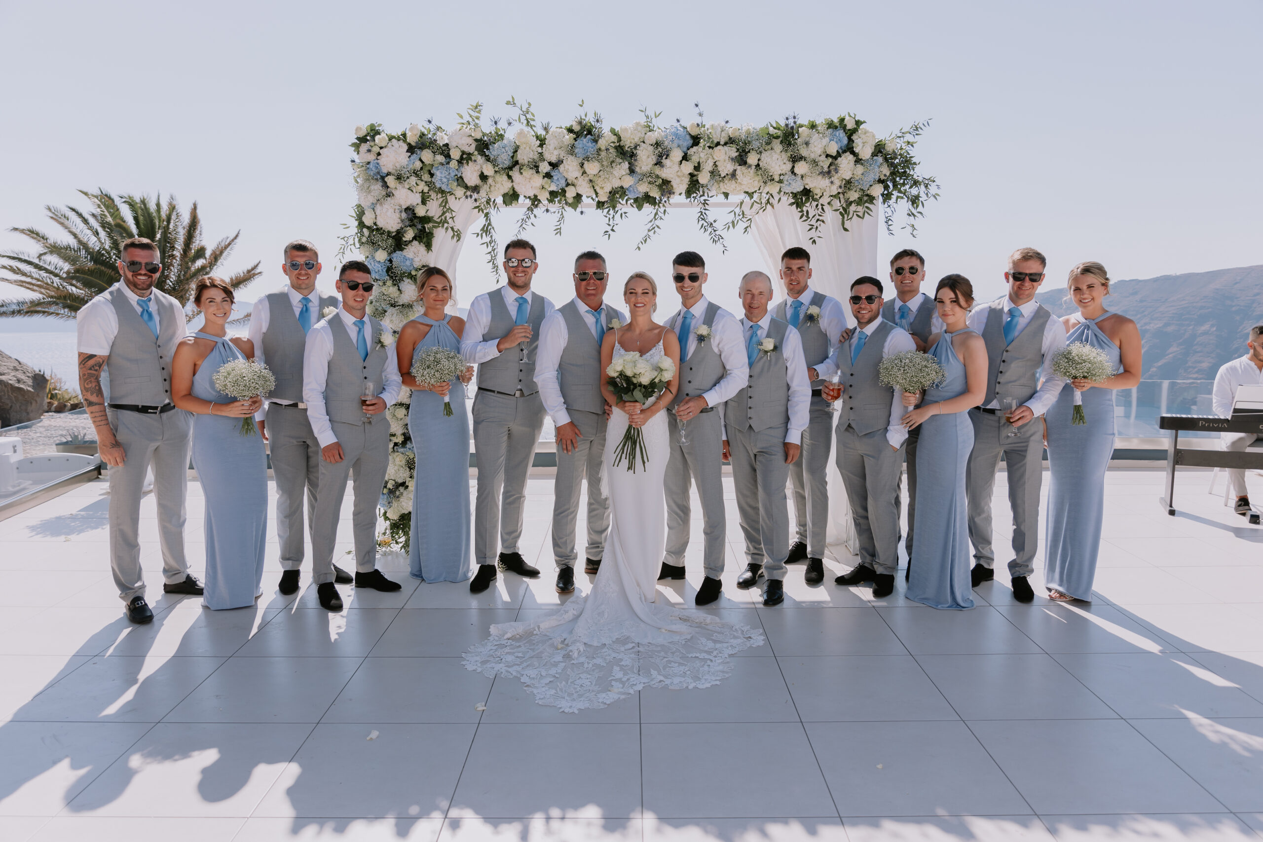 Destination wedding photo of bride, groom and wedding party in Santorini