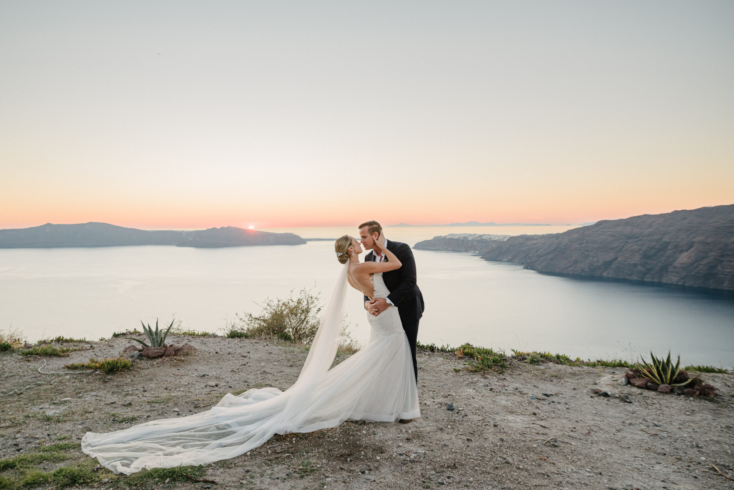 must-have destination wedding photo of bride and groom dancing in front of sunset
