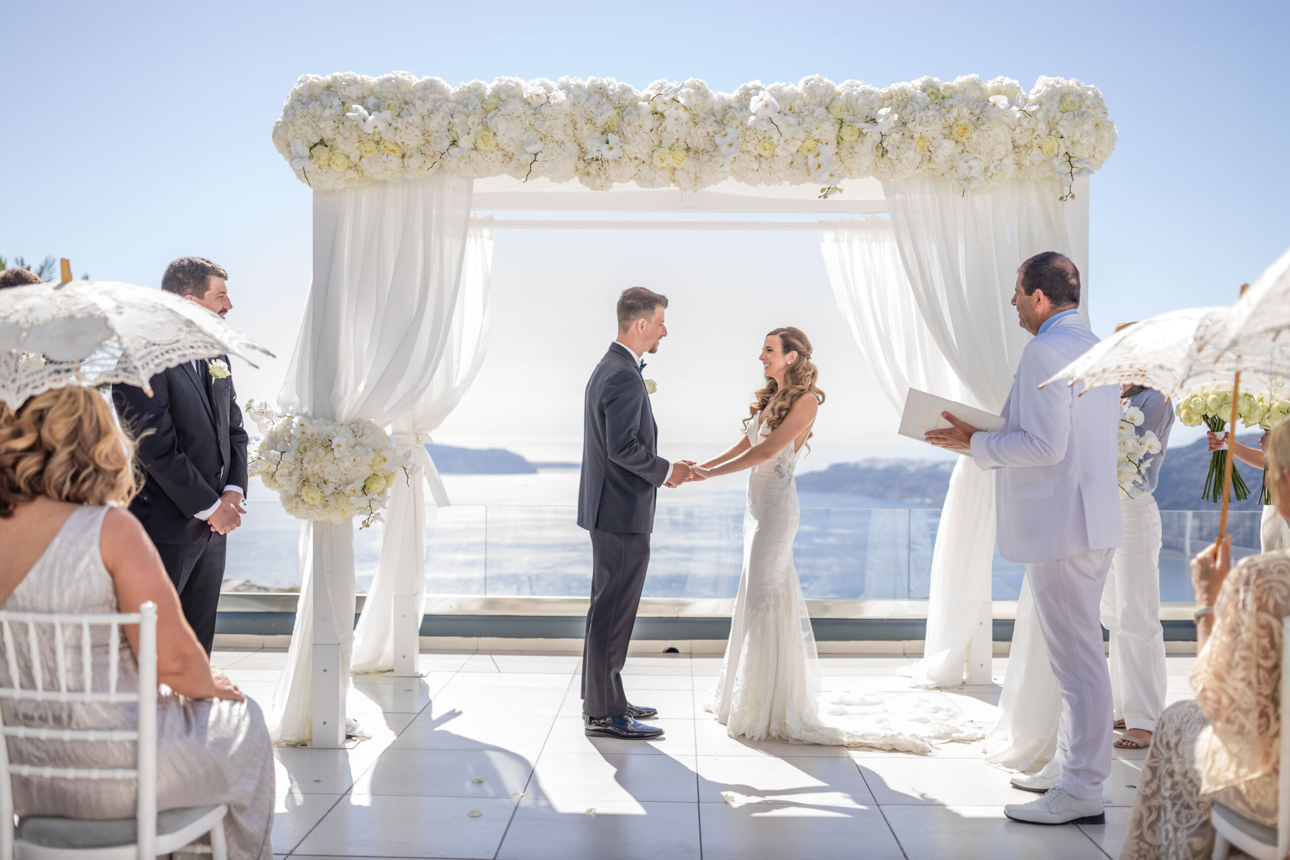 Bride and groom sharing vows at Le Ciel wedding venue in Santorini