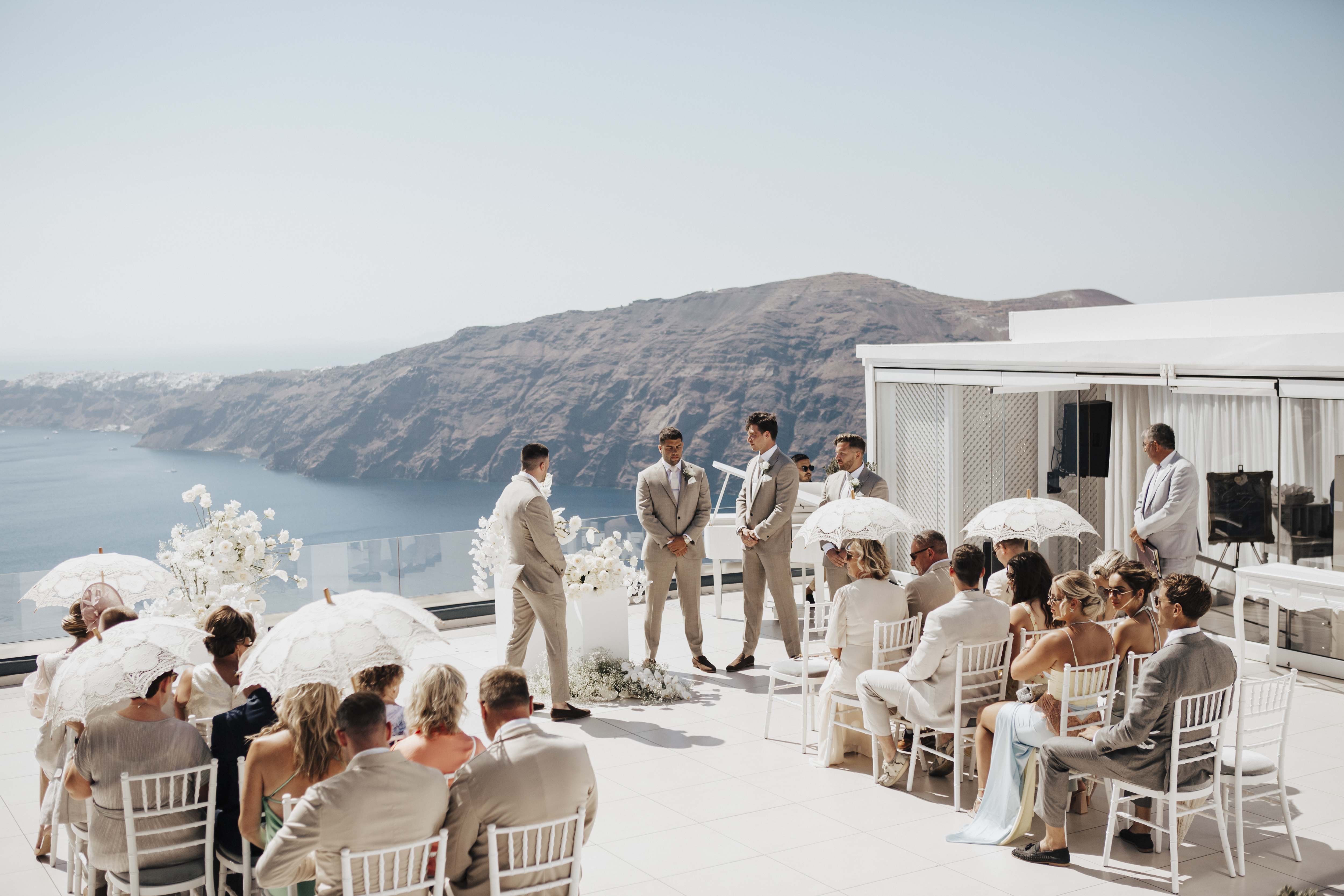 groom waiting for bride at the top of the aisle at Santorini destination wedding