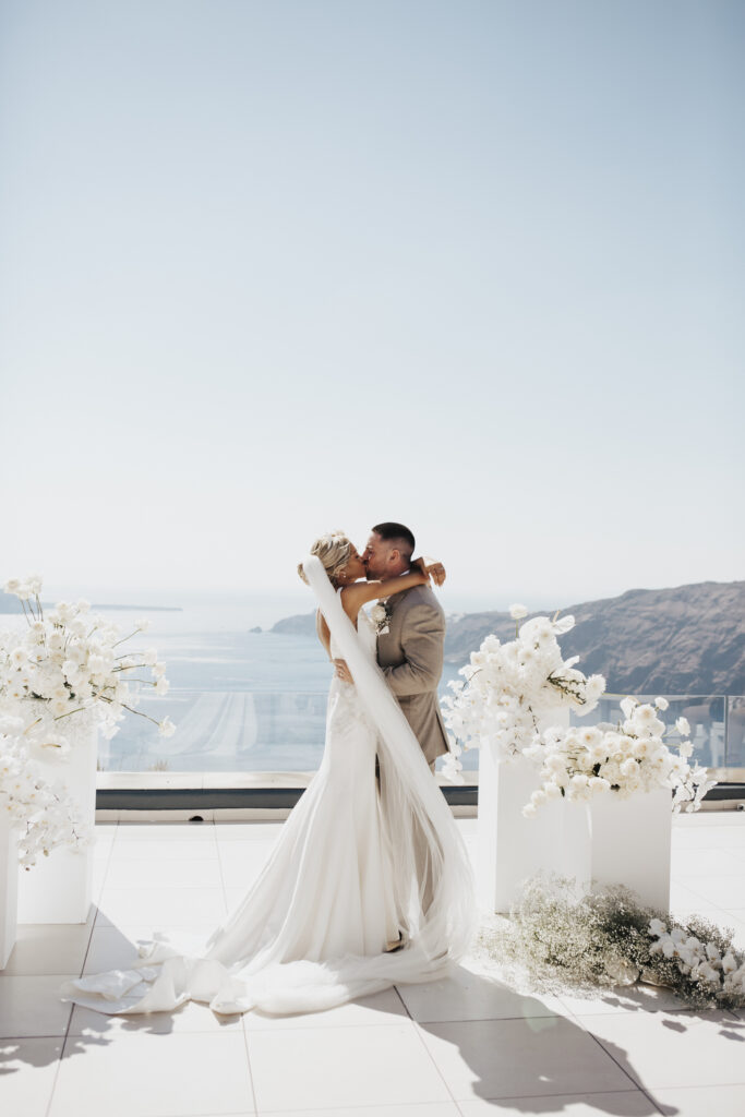 bride and groom kissing after marrying at Santorini destination wedding