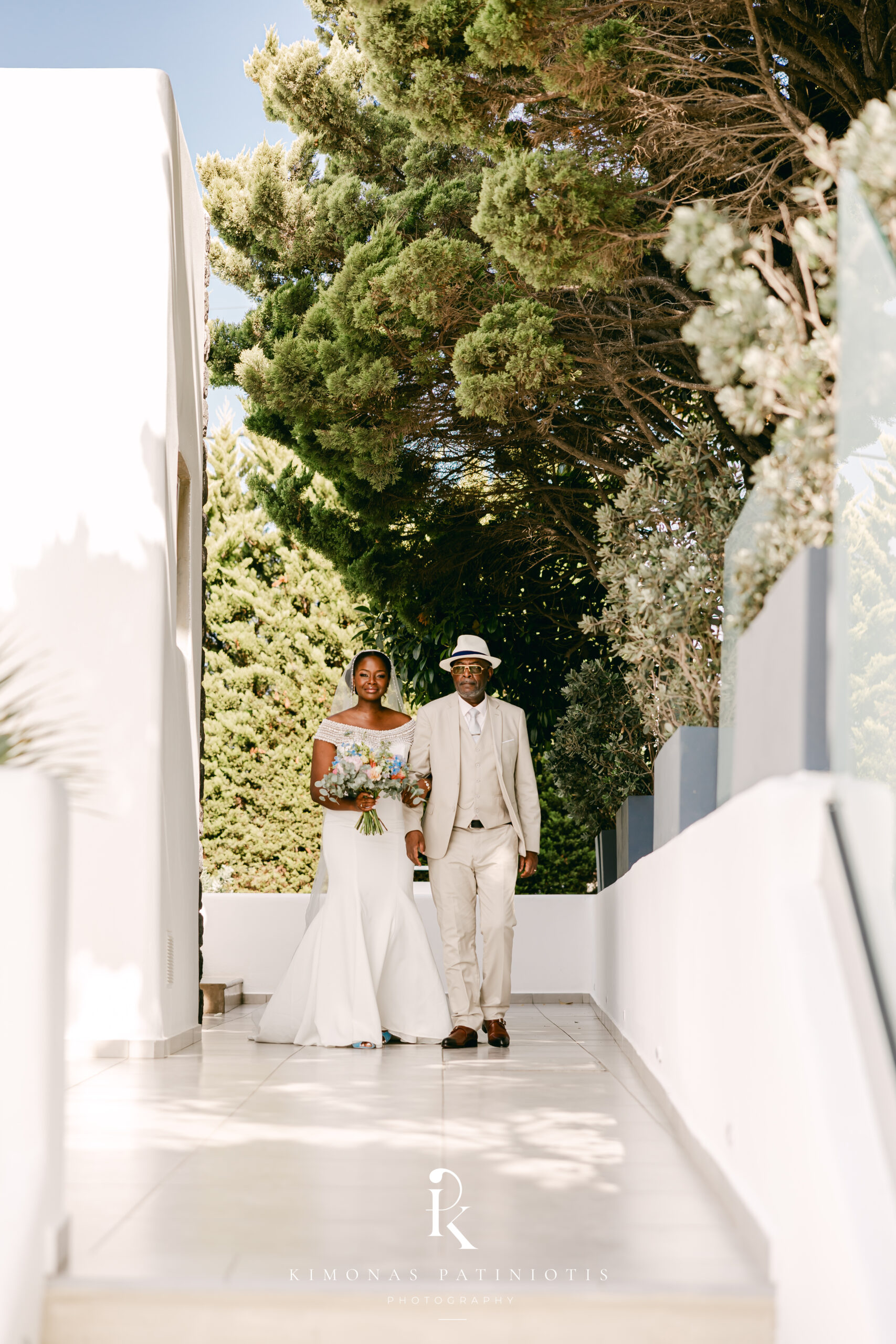 bride and her father walking through Le Ciel Santorini wedding venue