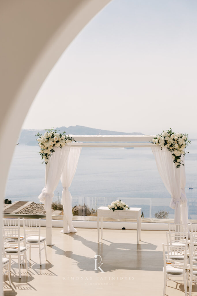 wedding ceremony setup with white flowers for destination wedding in Santorini