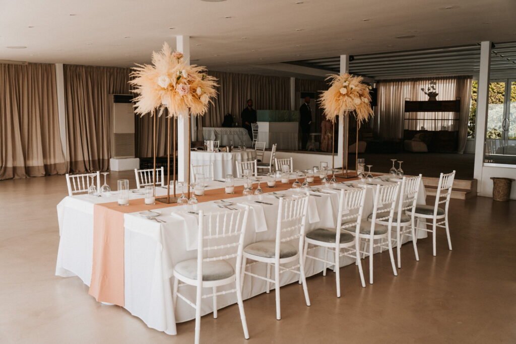 reception set up at Le Ciel destination wedding with warm neutral flowers