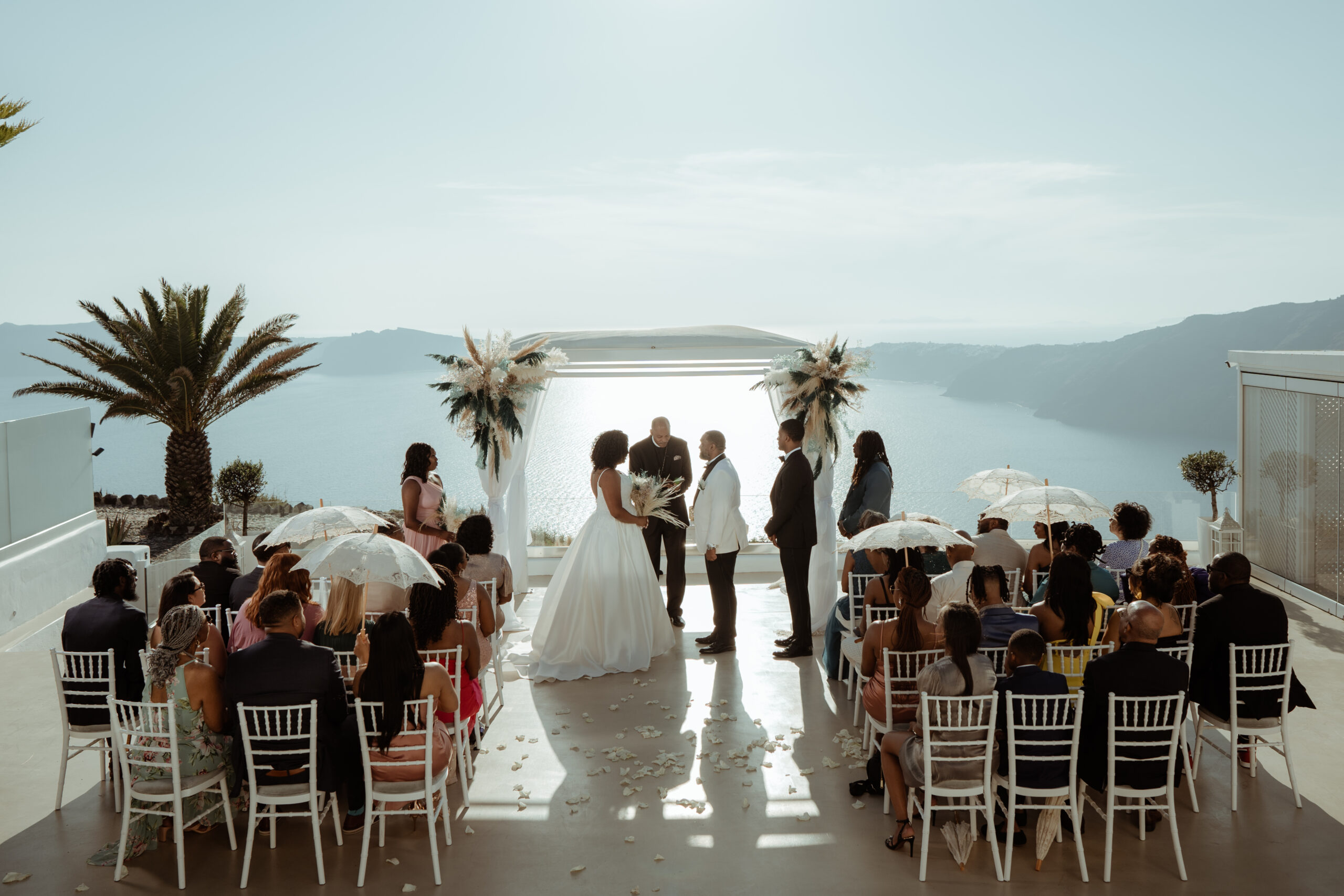 Stephanie and Vincent exchanging vows at Le Ciel Santorini