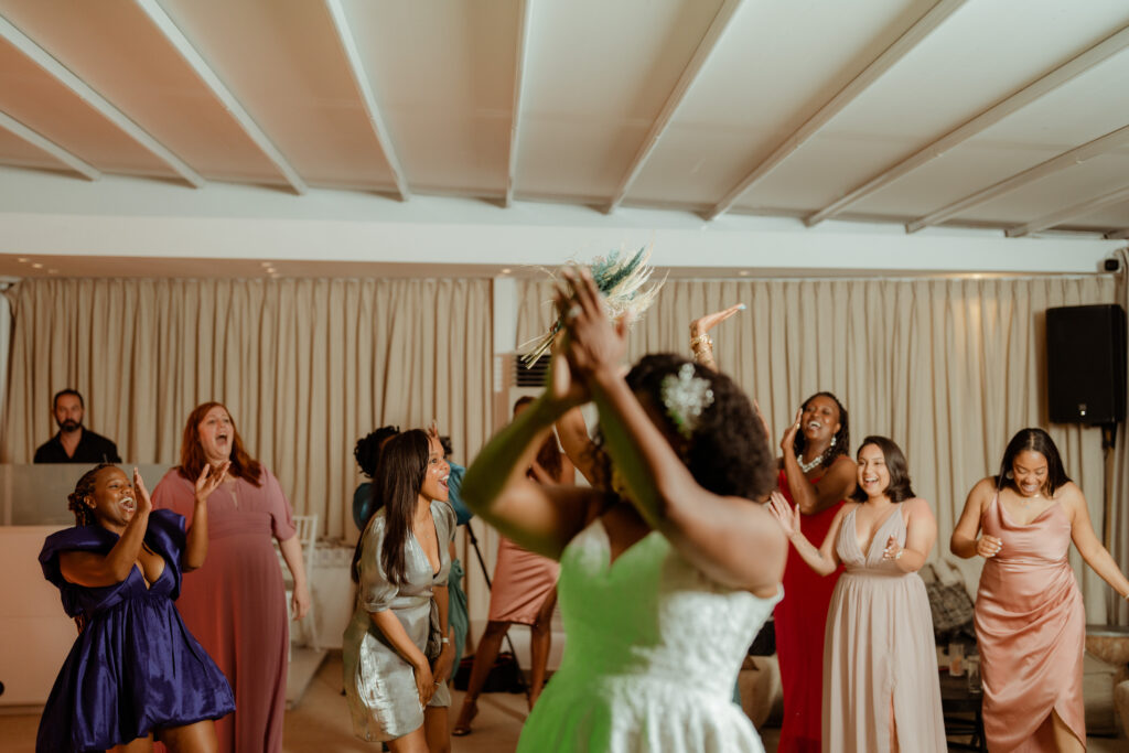 bride throwing the bouquet for guests to catch