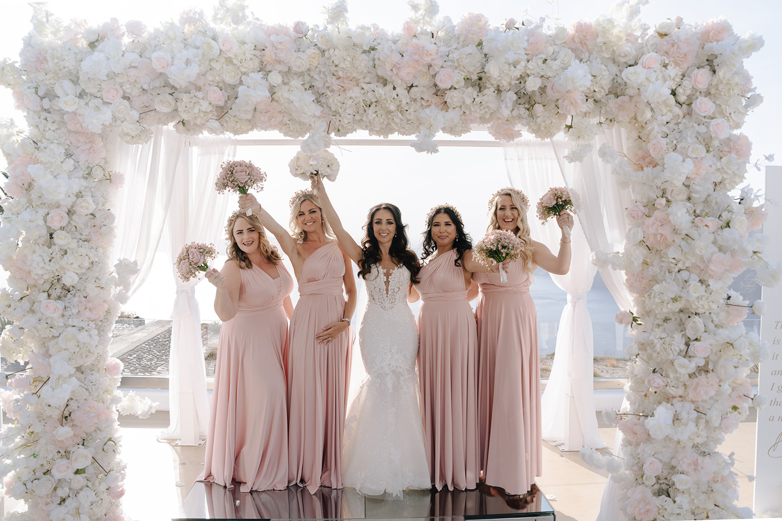 bride and bridesmaids wearing pale pink dresses at destination wedding