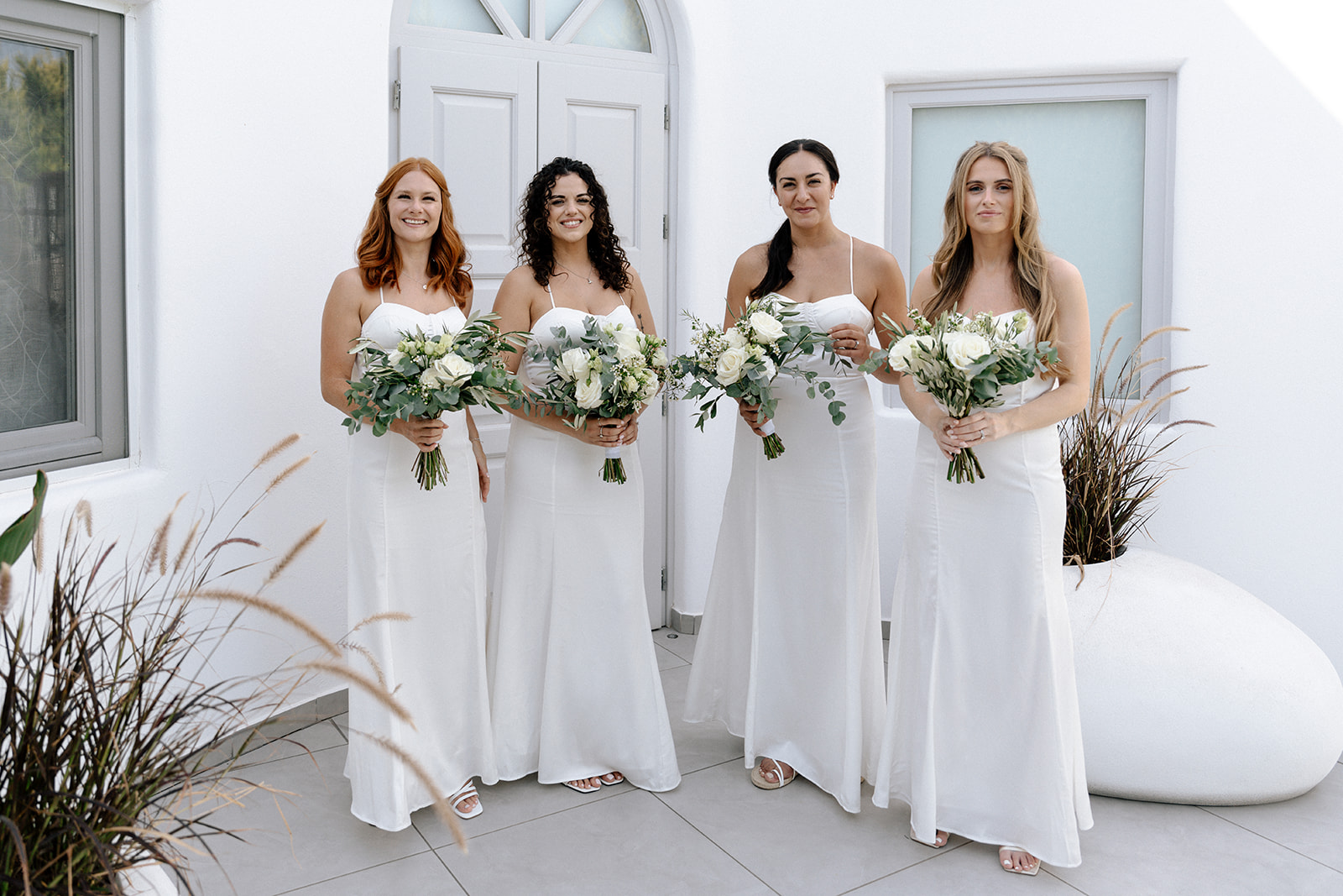 bridesmaids wearing white maxi dresses