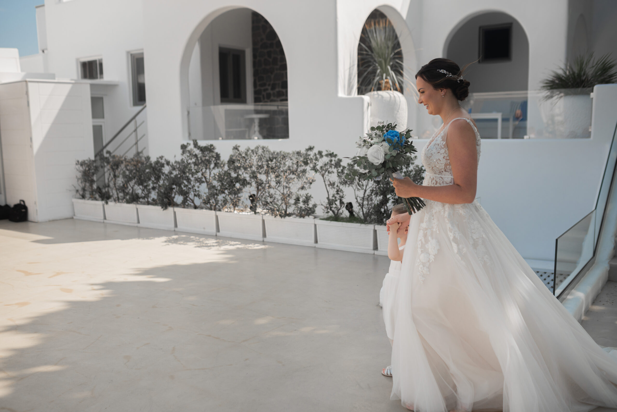 bride walking through courtyard at Santorini destination wedding