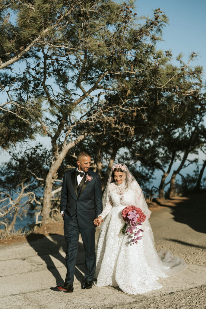 bride and groom walking through Santorini woodland