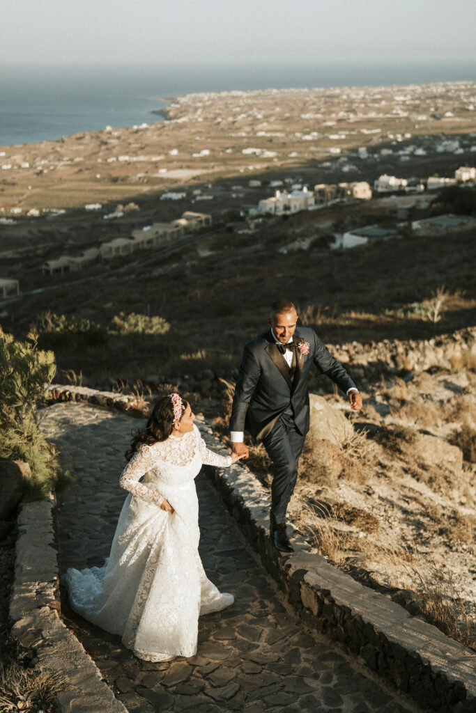 bride and groom walking through Santorini countryside