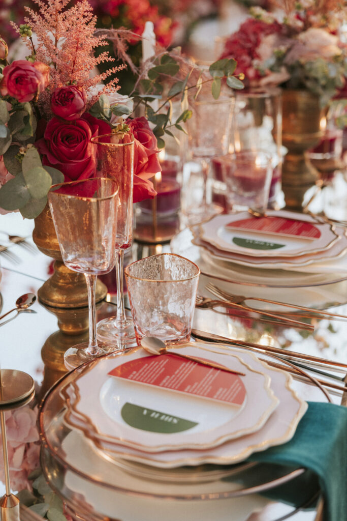 reception table set up with pink flowers and glassware