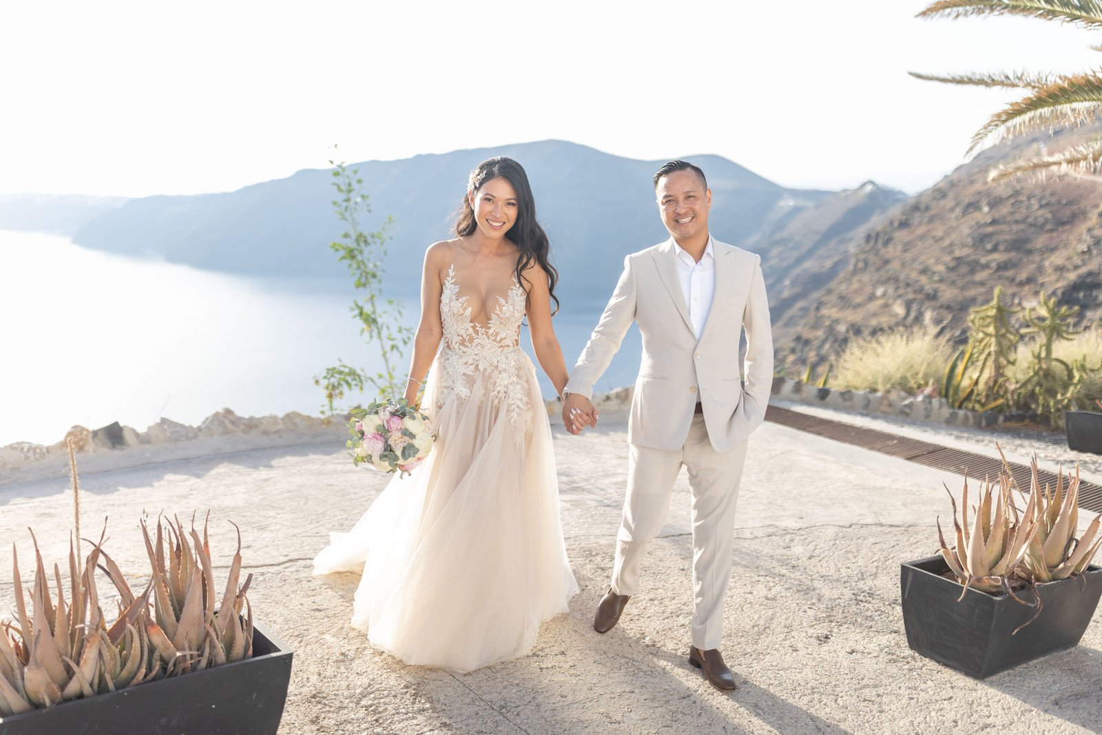 smiling bride and groom outside Le Ciel wedding venue in santorini