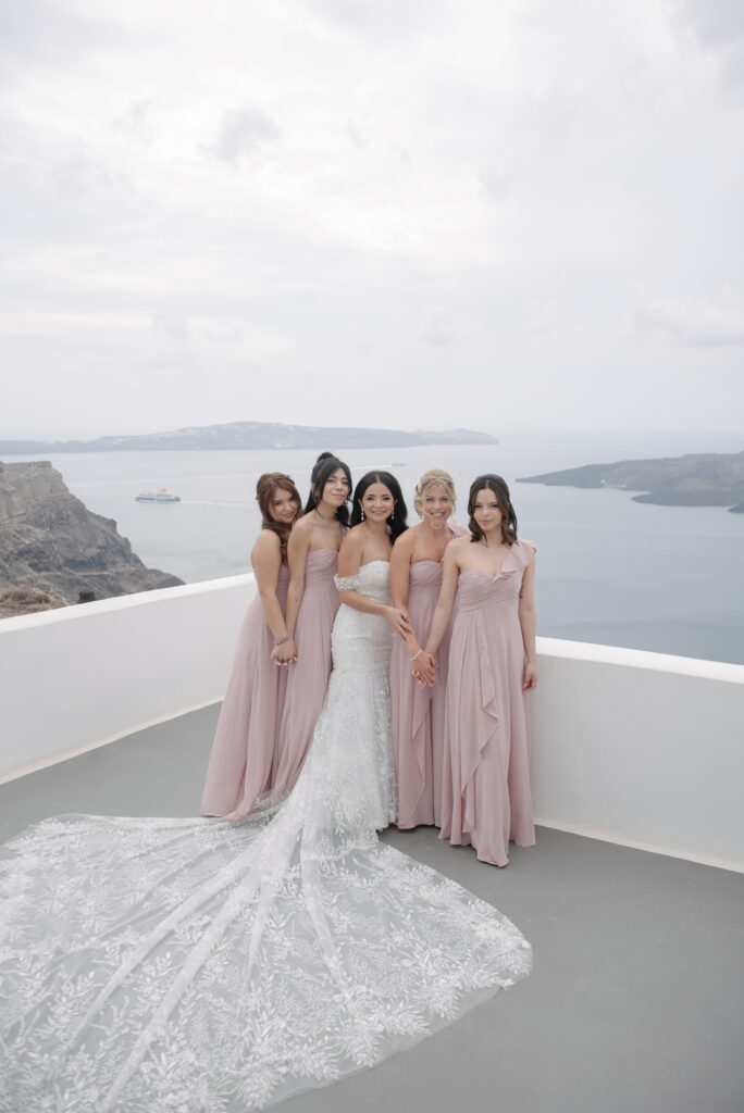 Carol and her bridesmaids with a view of the sea behind them