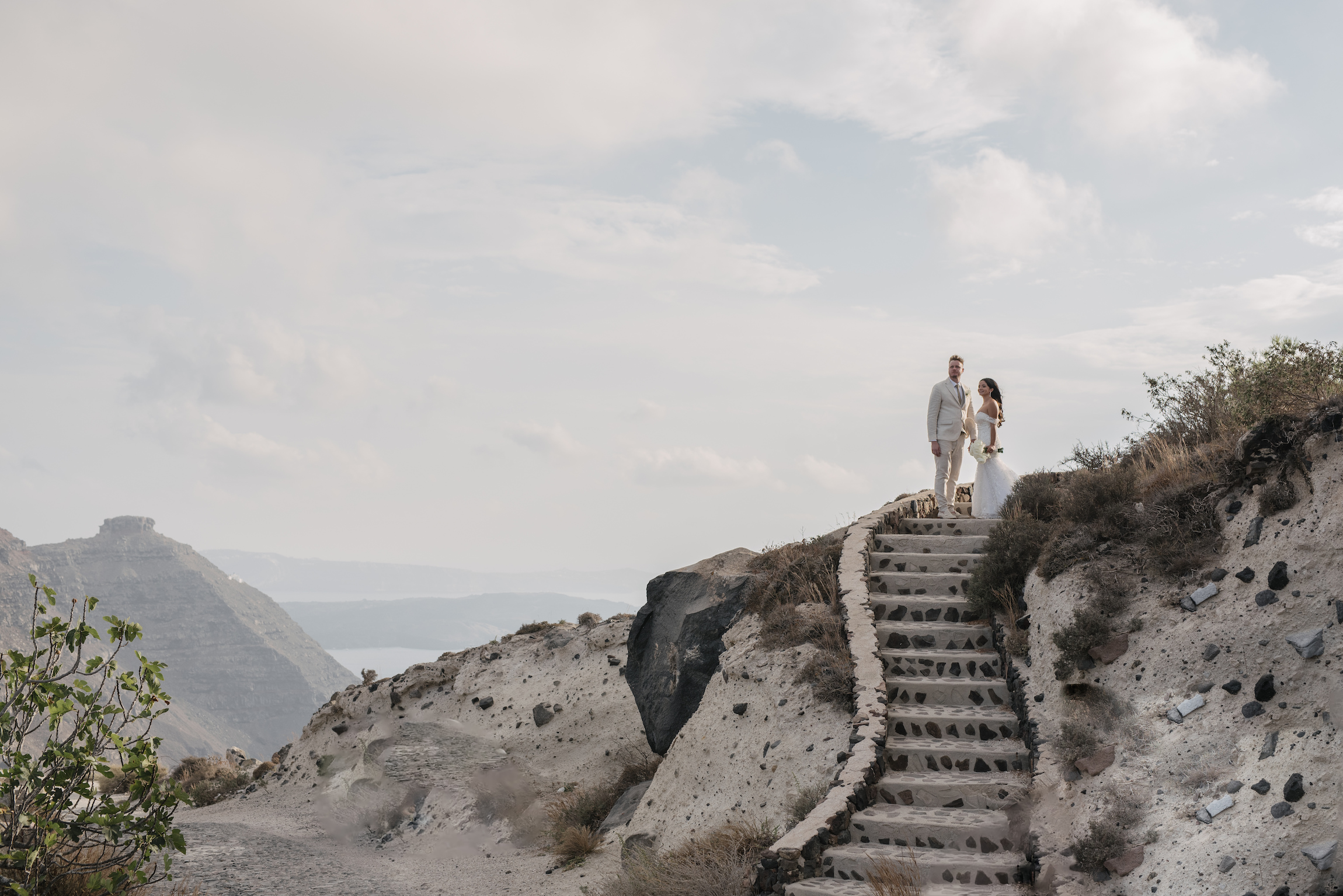 bride and groom at the top of a stone staircase