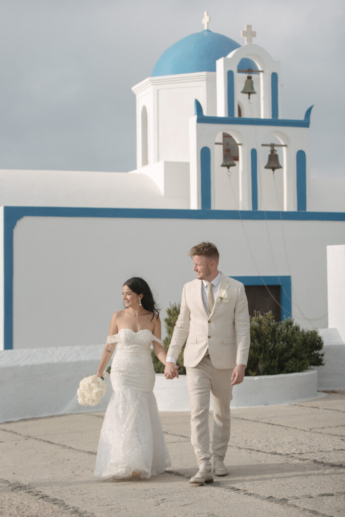 bride and groom walking through the old streets of Santorini