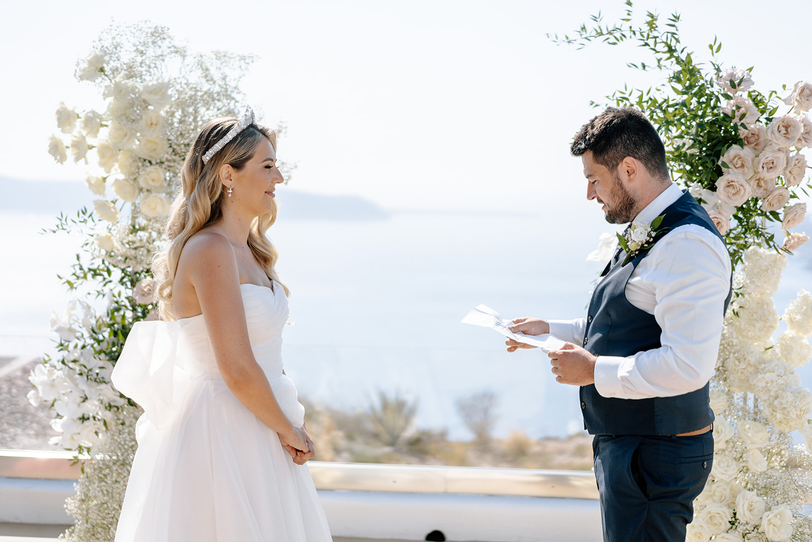 groom reading at his destination wedding to his bride