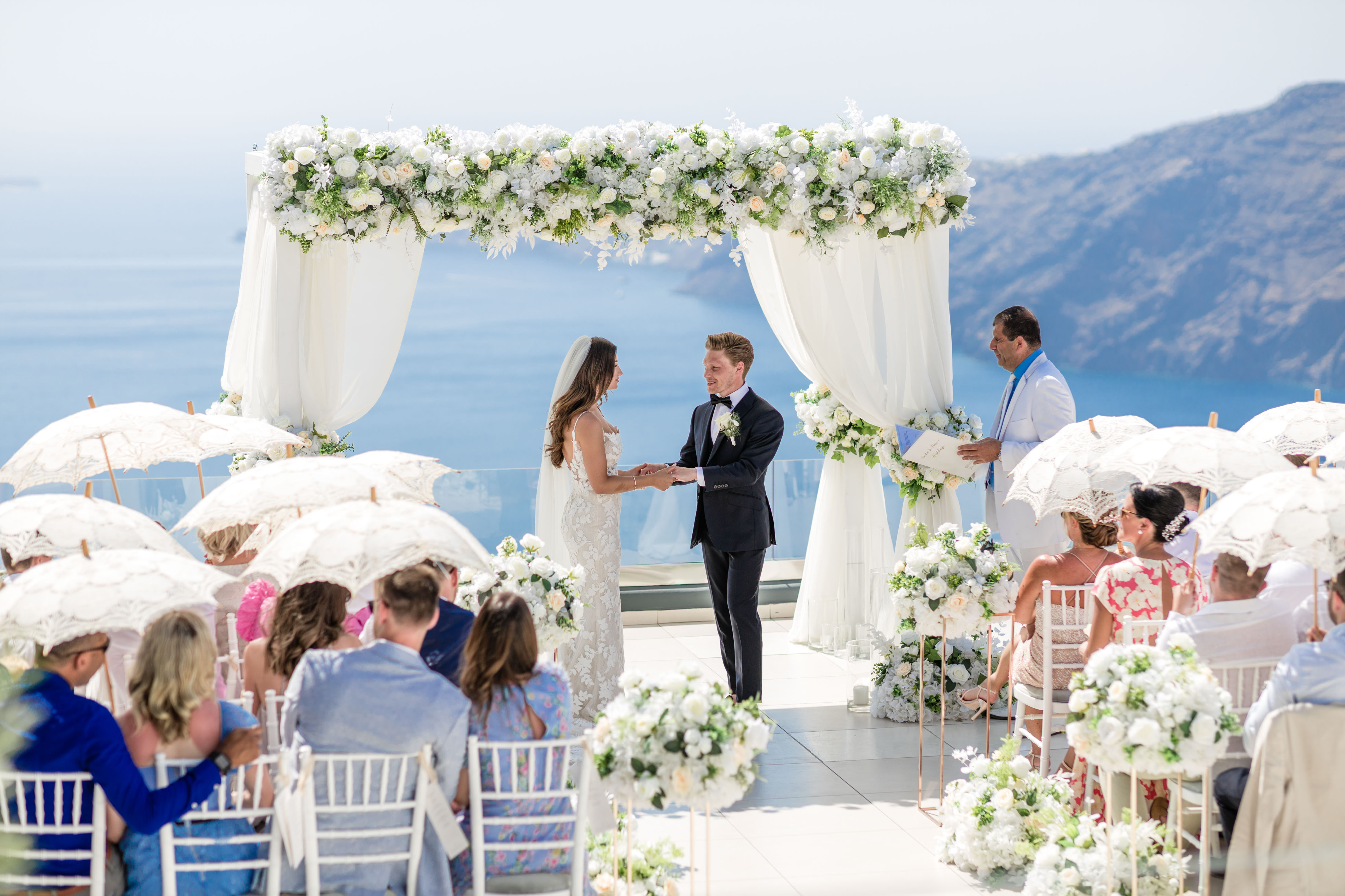 bride and groon marrying at Le Ciel in Santorini with readings for a destination wedding