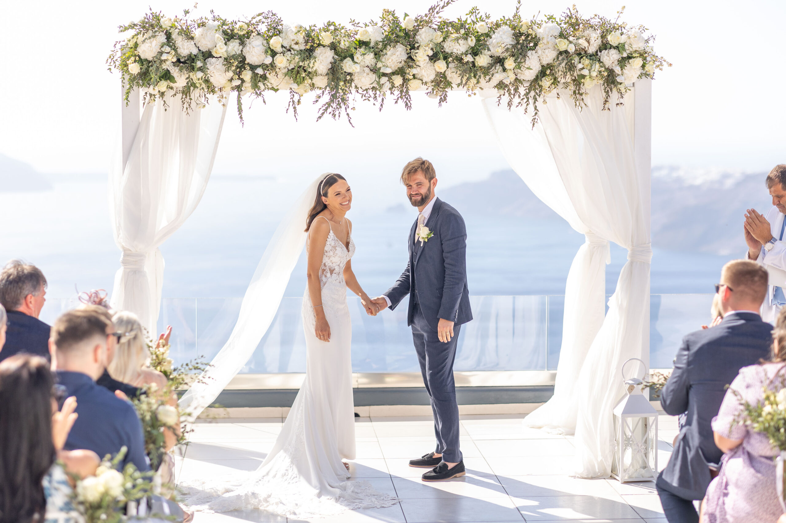 bride and groom holding hands during readings for a destination wedding at Le Ciel