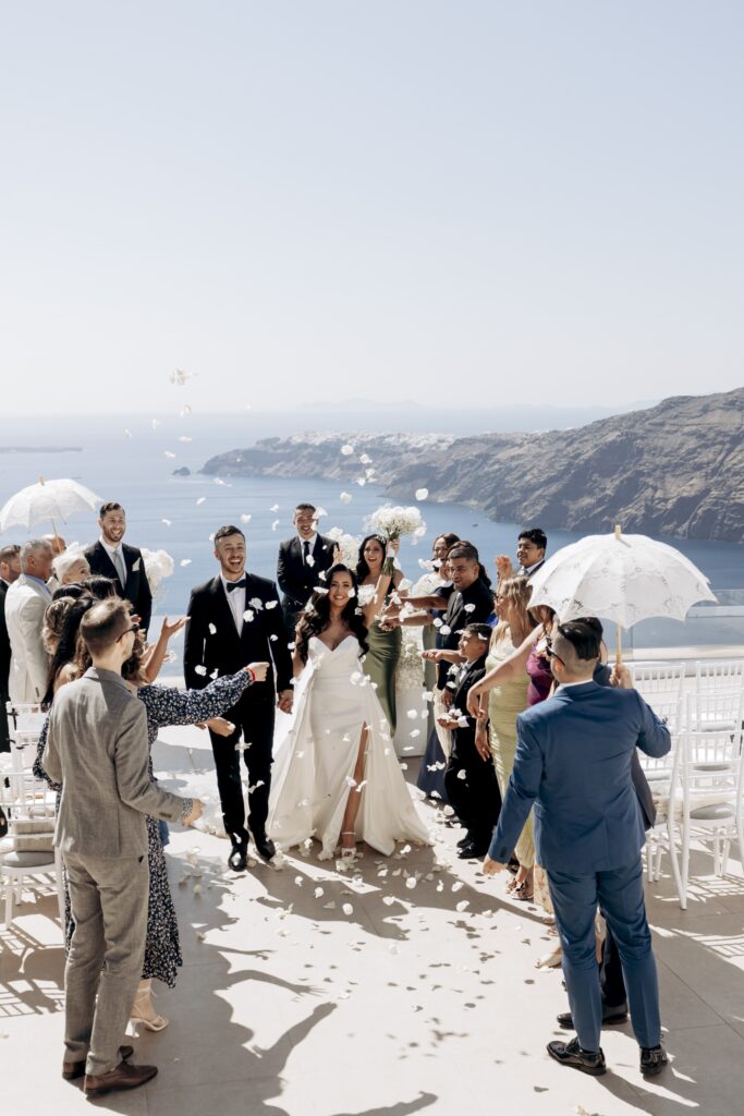 bride and groom covered in rose petal confetti